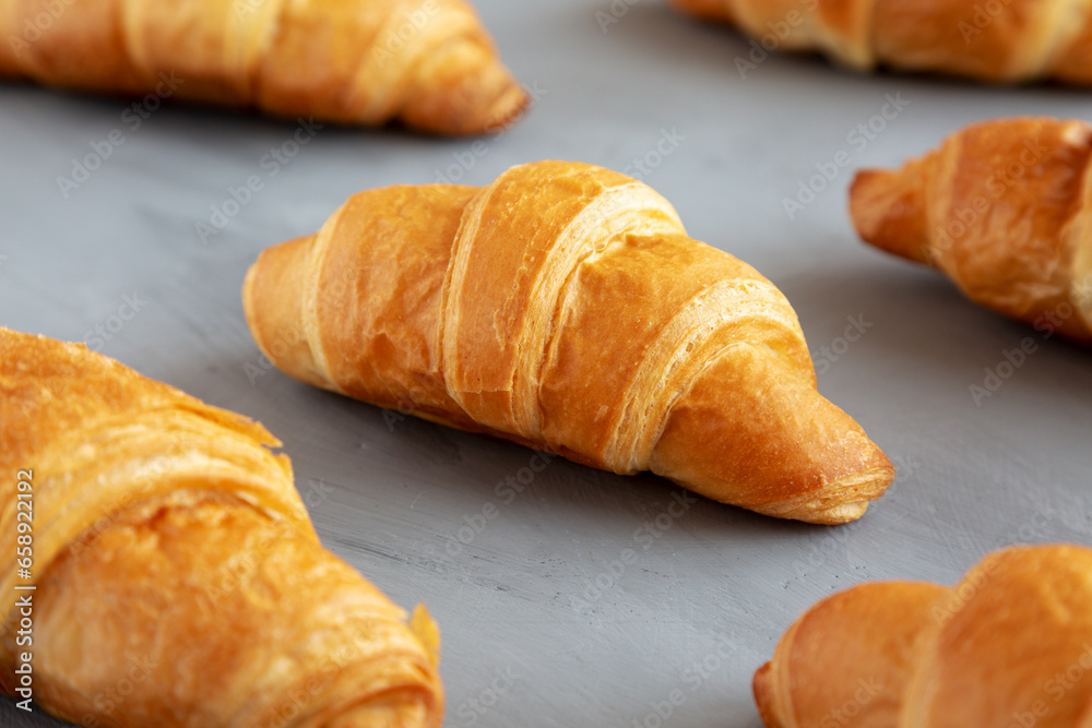 Homemade Croissants on a gray background, side view.