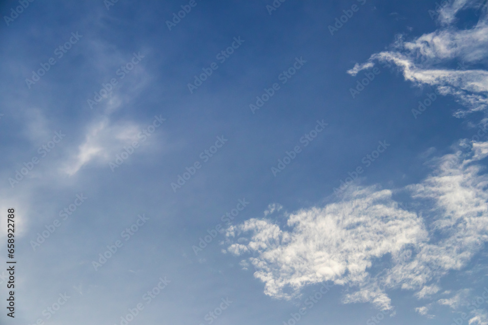 Blue sky with fluffy clouds; soft white clouds on blue sky. Skyscraper background.
