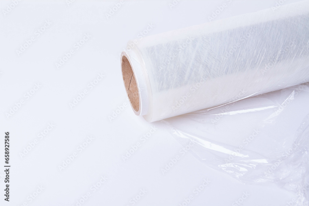 Obraz premium Packing the goods in a cardboard box and stretch film. Tools for packing parcels at the post office.