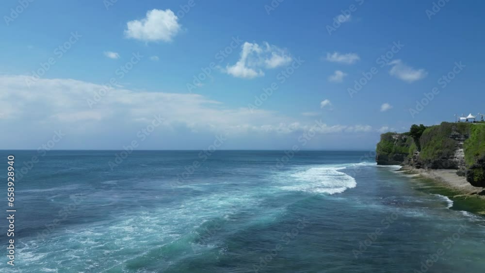 Panoramic aerial shot of the Indian Ocean around Bali. Dreamland beach, tourist and spectacular beach for swimmers and surfers who love to ride the ocean waves of this island. (Bali, Indonesia). Panoramic aerial shot of the Indian Ocean around Bali. Dreamland beach, tourist and spectacular beach for swimmers and surfers who love to ride the ocean waves of this island. (Bali, Indonesia).