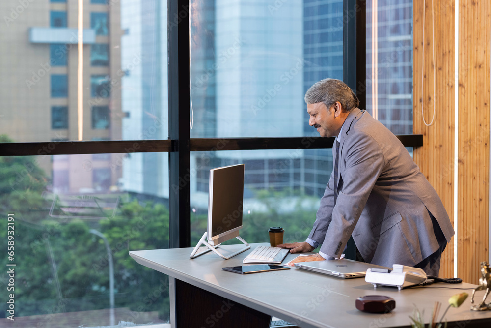 Businessman working on computer in in a modern office Businessman working on computer in in a modern office
