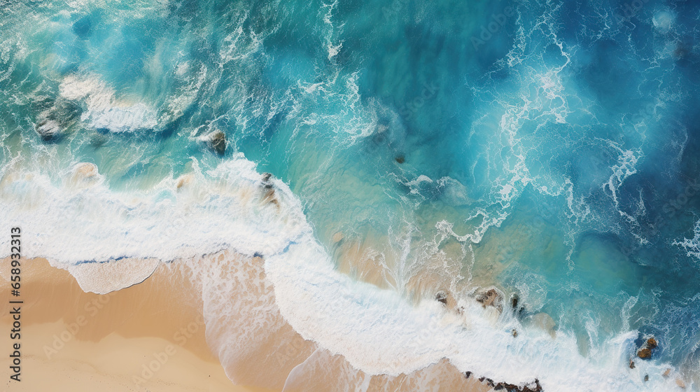 An aerial view captures crashing waves along the shoreline of a tropical beach, offering an abstract perspective of the ocean's dynamic surf An aerial view captures crashing waves along the shoreline of a tropical beach, offering an abstract perspective of the ocean's dynamic surf