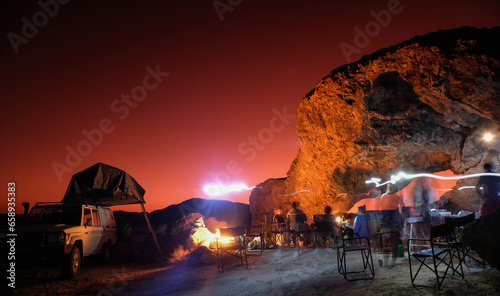 Night photo with moving flashlights, people and a rock arch, Namibia, Africa