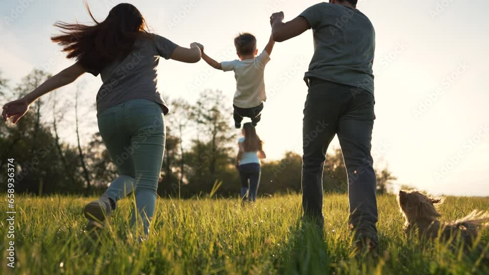 Happy family on grass with pet. Picnic in park with dog. Summer vacation on green meadow.People play run on grass.Family run in nature holding hands.Animal love for people.Family walk with dog in park