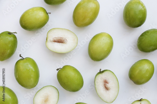 Green jujube fruits on white background.