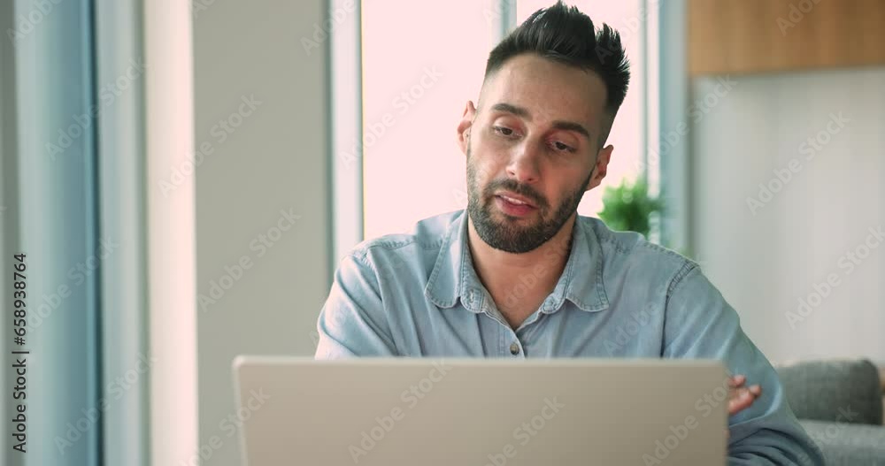 Lively Hispanic business man work remotely hold negotiations with client use laptop and videoconference application, explain strategy, share information take part in virtual meeting. Online counseling
