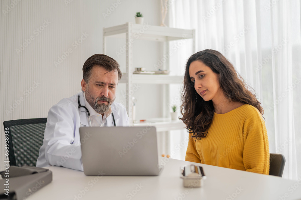 Male doctor talking to woman about illness in clinic. Caucasian docter to check up health female in examination hospital room. Healthcare and medical concept. Male doctor talking to woman about illness in clinic. Caucasian docter to check up health female in examination hospital room. Healthcare and medical concept.