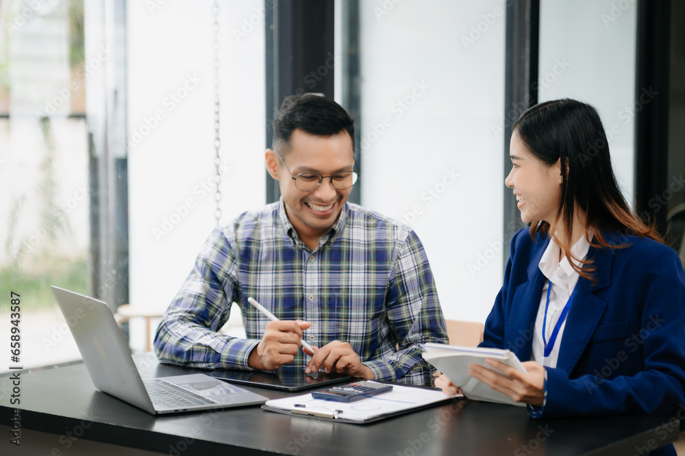 Female discussing new project with male colleague. Young woman talking with young man in office.. Female discussing new project with male colleague. Young woman talking with young man in office..