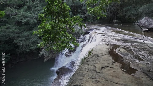 cascada la motilona, beautiful tropical waterfalls in the deep rainforest of the jungle near Paicol in Colombia cascading into a turquoise pool along the riverbed. photo