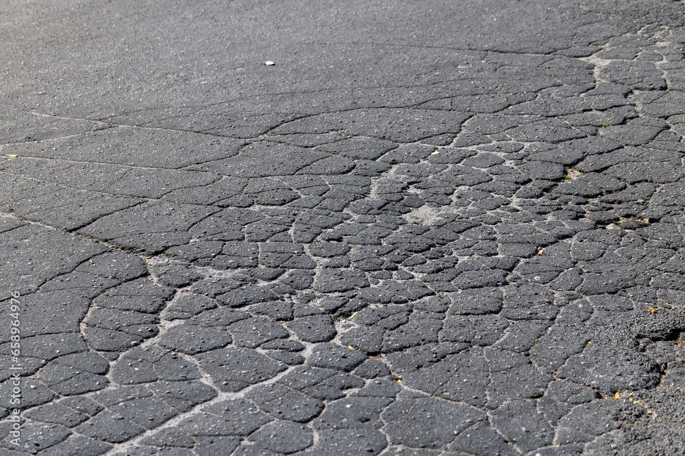 pits and cracks on the asphalt of the road pits and cracks on the asphalt of the road
