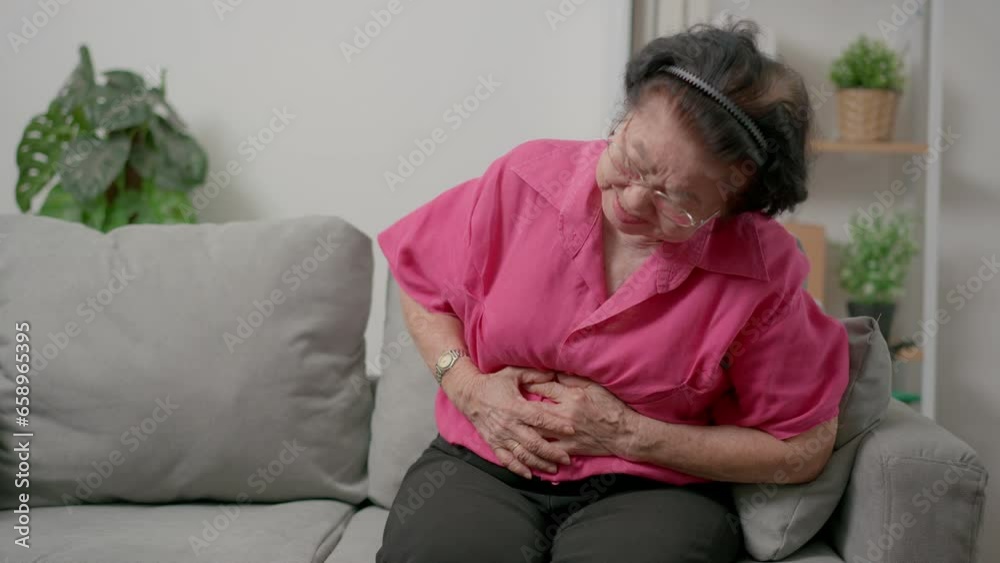 Unhealthy mature woman holding belly ,severe stomach ache caused by food poisoning inpatient has a bacterial infection. Concept of gastrointestinal system disease, digestion gastritis, abdominal pain Unhealthy mature woman holding belly ,severe stomach ache caused by food poisoning inpatient has a bacterial infection. Concept of gastrointestinal system disease, digestion gastritis, abdominal pain