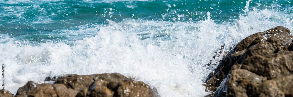 Sea water hits rocks on the beach By the sea with strong waves