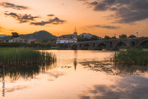 Sunset at the medieval bridge at Ponte de Lima, Portugal. photo