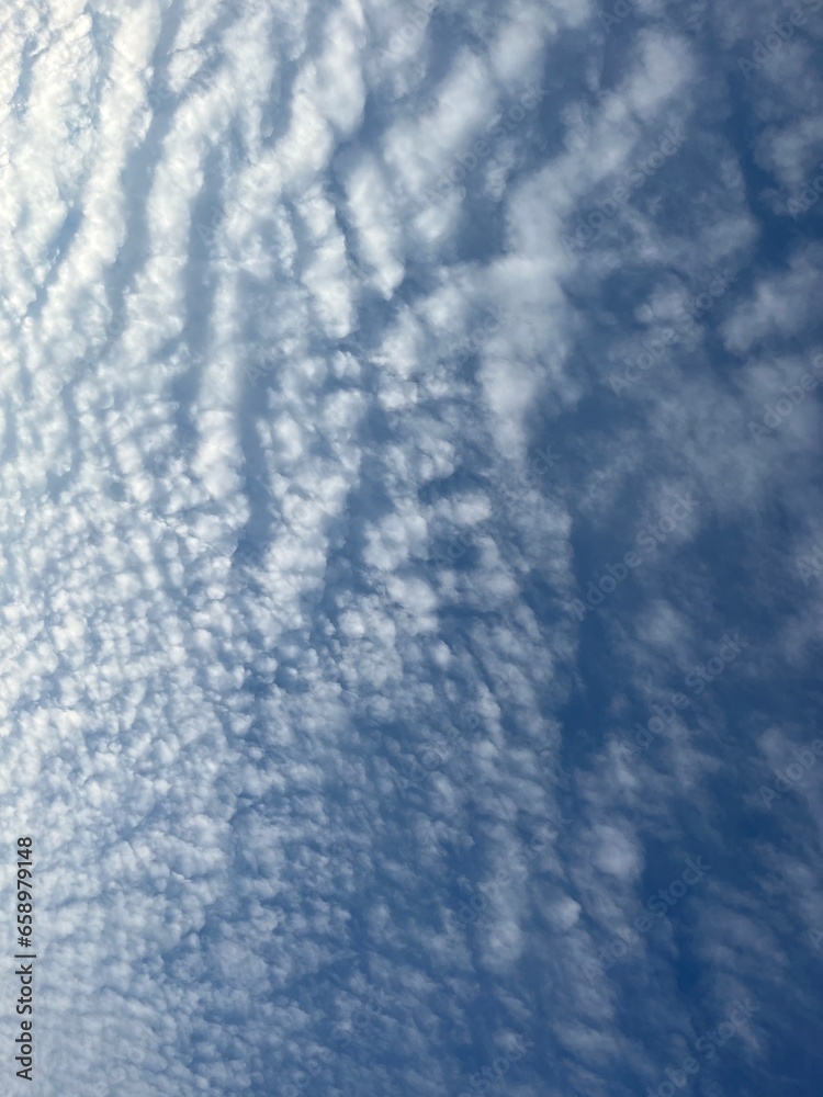 Blue sky with fluffy clouds, natural heavens background