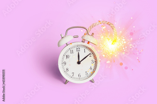 Creative vintage party clock bomb with wick and sparks on a pink background. Start of party and new year, creative idea. Deadline, concept