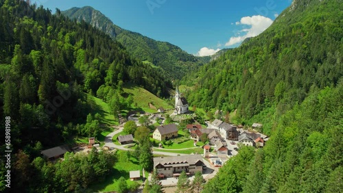 Alpine rural landscape with traditional Slovenian church in Kamnik Savinja Alps photo