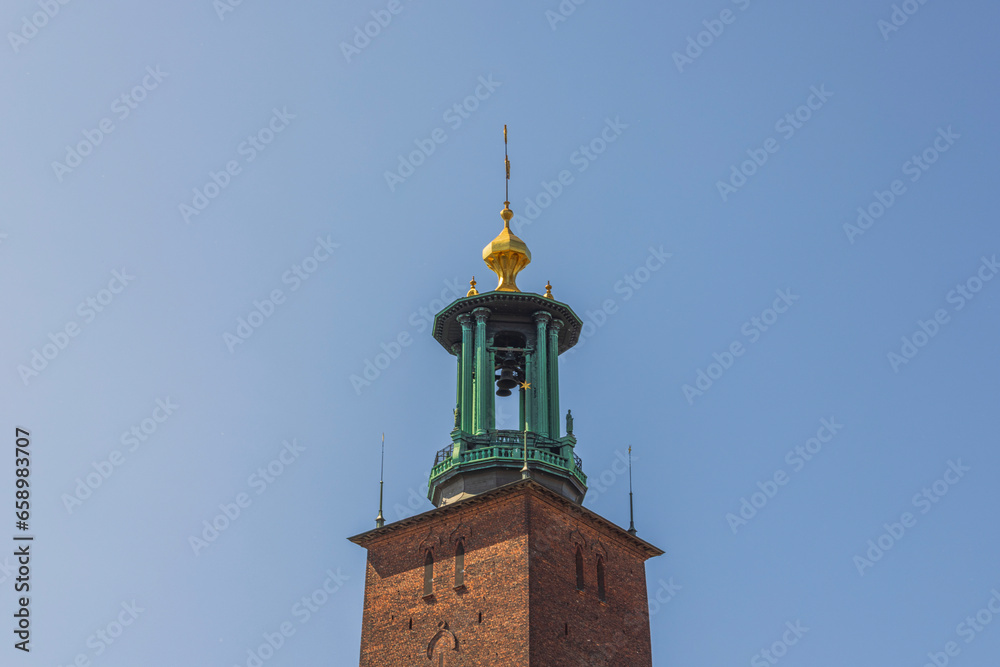 Close-up view of cathedral dome with bells on blue sky background. Sweden.