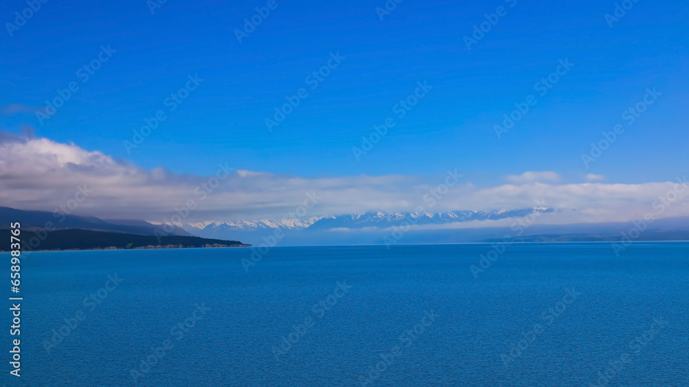 The mist in the morning with  mountain view of  alpine as snow-capped mount peaks and blue lake in Winter mountains