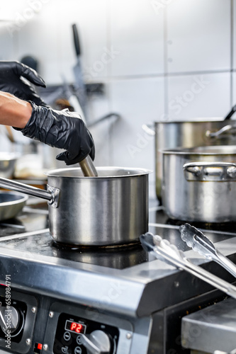 Chef hands cooking soup in the restaurant kitchen © pavel siamionov