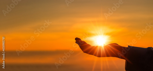 Silhouette of prayer woman worship God in the morning with sunrise sky background. Person hands open palm up worship. God helping repent catholic easter lent mind pray. Christian religion concept.