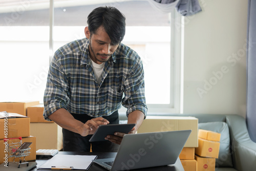 African American male manager who packs parcels in warehouse before sending orders to customers of online store, SME business concept