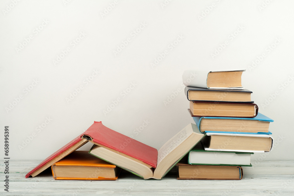 Open book, hardback colorful books on wooden table. Back to school. Copy space for text. Education business concept. Open book, hardback colorful books on wooden table. Back to school. Copy space for text. Education business concept.
