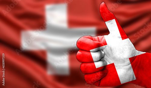 thumbs up in approval with the Swiss flag painted