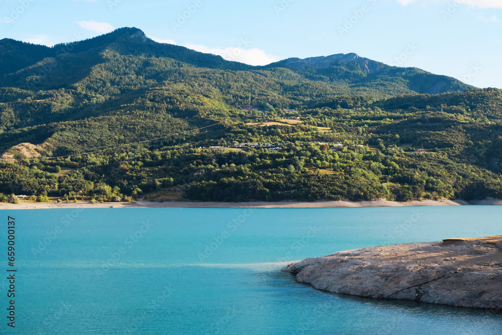 Lake of Serre-Poncon, reservoir and popular nature attraction on the border in the Provence-Alpes-Cote d'Azur region, Southeastern France. Lake of Serre-Poncon, reservoir and popular nature attraction on the border in the Provence-Alpes-Cote d'Azur region, Southeastern France.