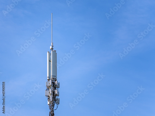 A 4g cell tower with a blue sky as a background.