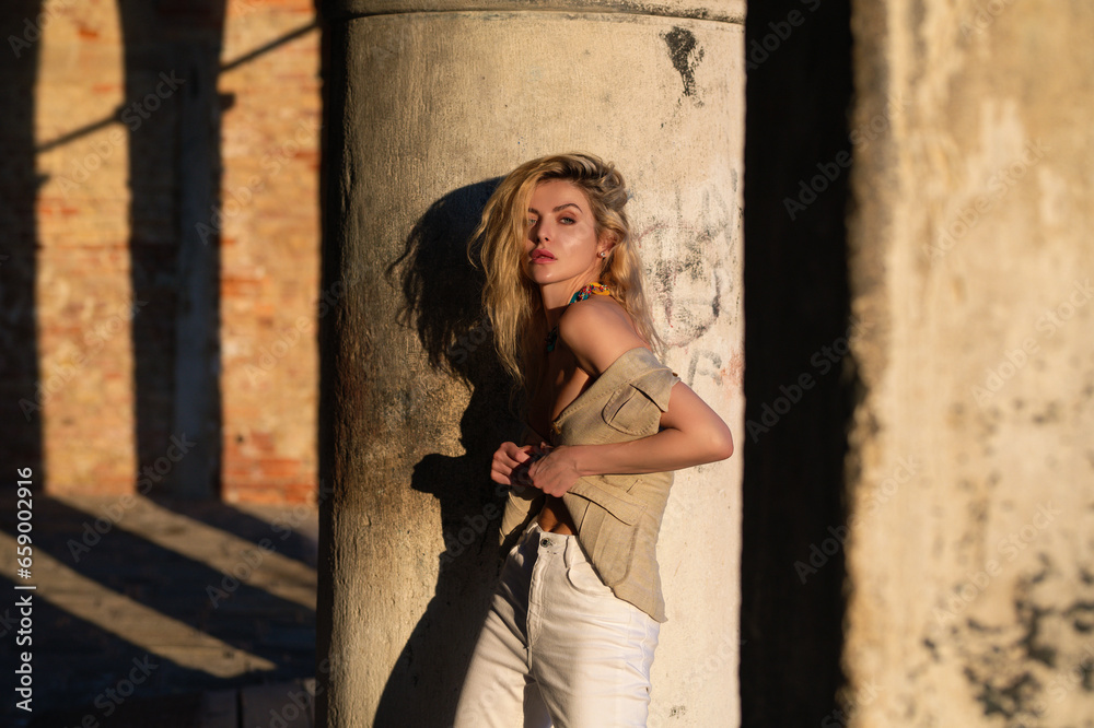 Fototapeta premium Outdoors fashion lifestyle. Beautiful fashion woman. Fashions woman posing on street. Sexy model outdoors portrait. Fashion woman young pretty trendy girl posing at city, summer street fashion.