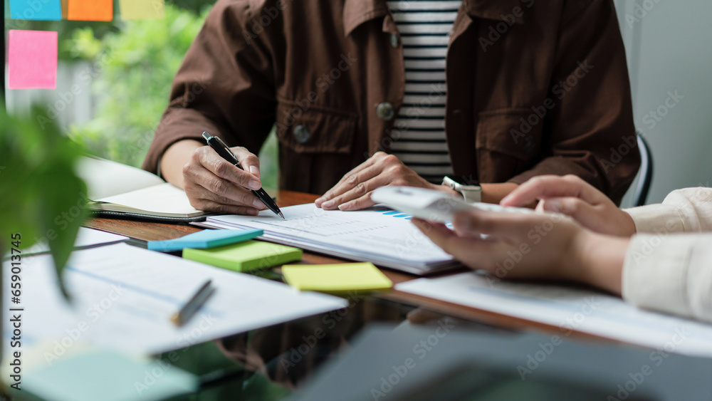 Business colleague checking budget with calculator and brainstorming about financial of business Business colleague checking budget with calculator and brainstorming about financial of business