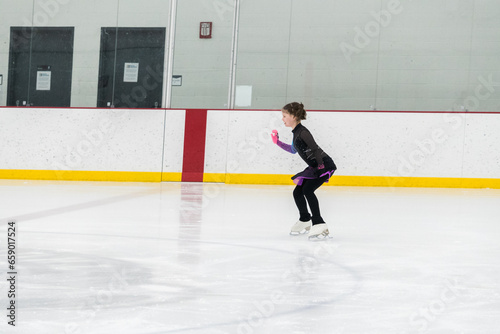 Figure skating practice at an indoor skating rink