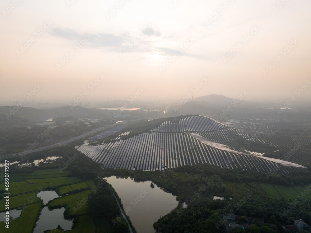 Fototapeta premium view of solar power panels on hill