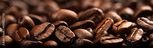 Closeup of brown roasted coffee beans on a dark background