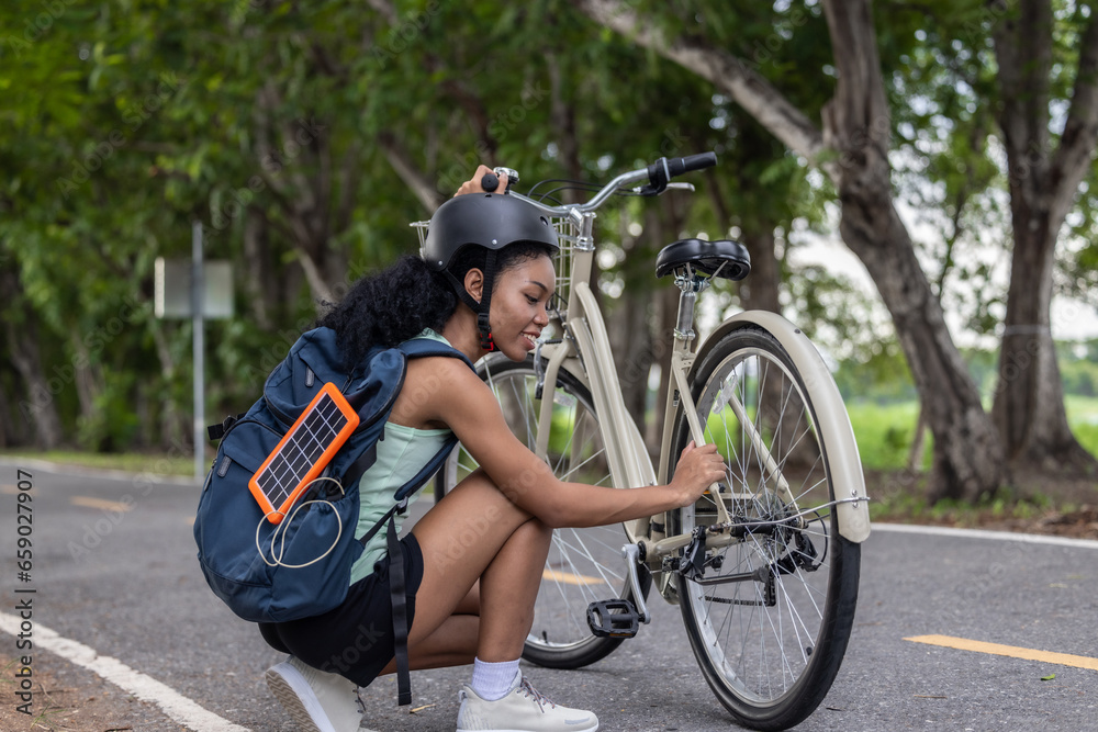 Obraz premium Biker fuse eco-awareness, cycling for fitness, solar for device power, and recycling into lifestyle