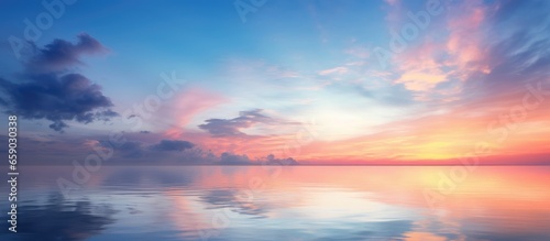 Stunning long exposure of sky at sunrise or sunset with reflected clouds and tropical sea