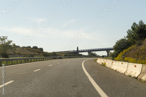 cars driving on a Spanish highway with three lanes and modern cars