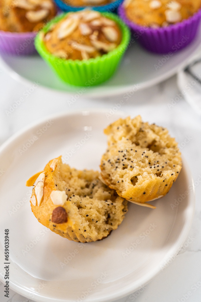 Lemon poppy seed muffins garnished with almond slivers Lemon poppy seed muffins garnished with almond slivers