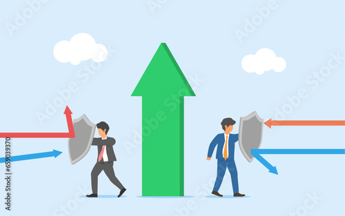 Protecting business growth. Team work to maintain business stability. two business people holding shield to withstand attacks.