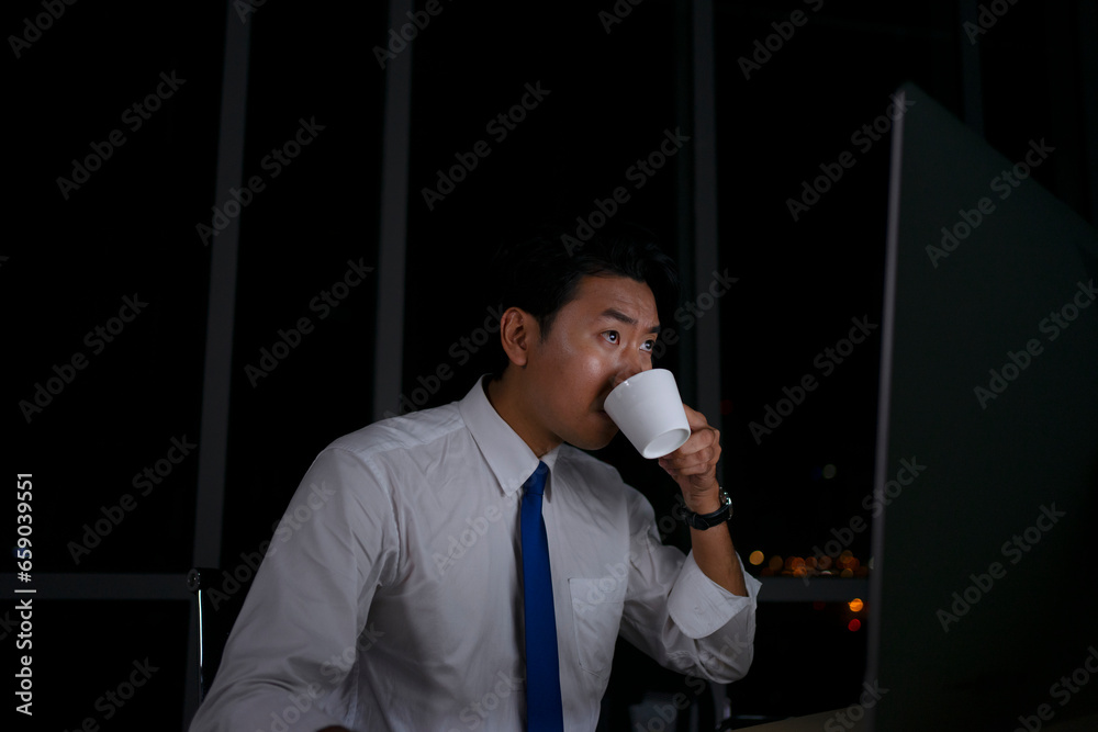 White collar worker working late at night. White collar worker working late at night.