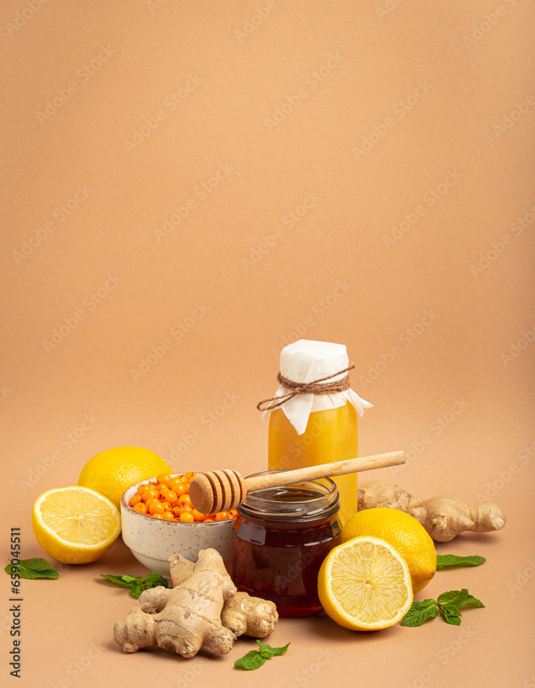 Composition with detox drink, sea buckthorn berries, lemons, mint, ginger, honey in glass jar. Food for immunity stimulation and against flu. Healthy natural remedies to boost immune system. Composition with detox drink, sea buckthorn berries, lemons, mint, ginger, honey in glass jar. Food for immunity stimulation and against flu. Healthy natural remedies to boost immune system.