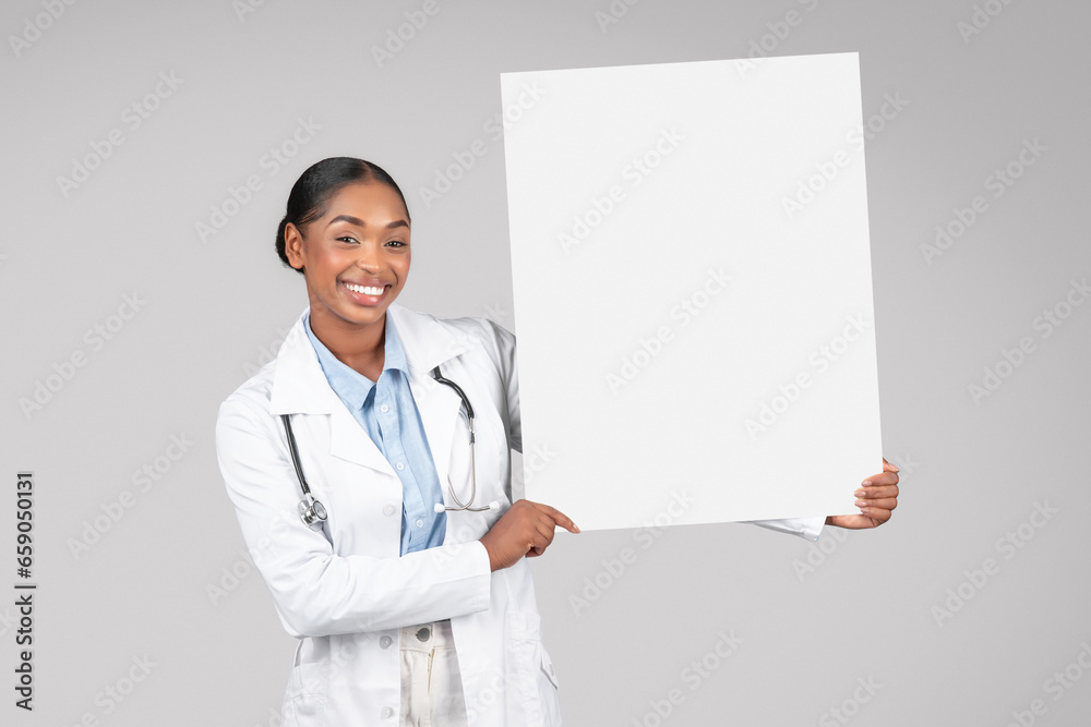 Black woman doctor smiling, holding a banner, studio Black woman doctor smiling, holding a banner, studio