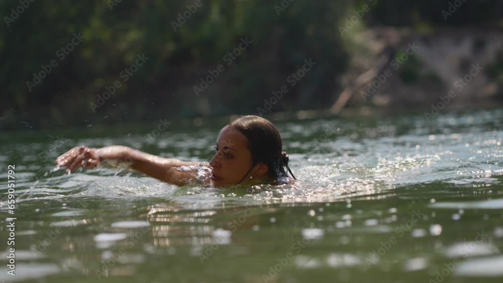 young tanned sexy woman on summer vacation or holiday swimming in alpine mountain lake, standing up from cold fresh clean water to get refreshed in heat, natural outdoor lifestyle young tanned sexy woman on summer vacation or holiday swimming in alpine mountain lake, standing up from cold fresh clean water to get refreshed in heat, natural outdoor lifestyle
