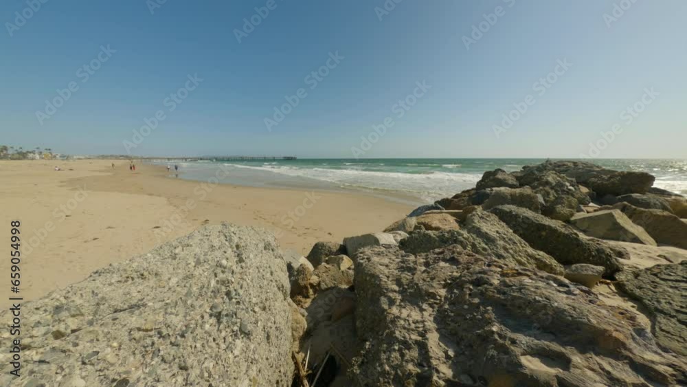 Sandy beach and ocean with waves. A beautiful white sand beach with clear blue water. Sandy beach and ocean with waves. A beautiful white sand beach with clear blue water.