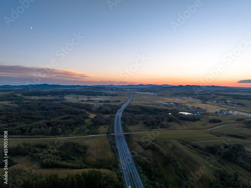 aerial view of highway in countryside at sunset