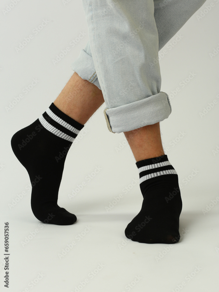 black and white socks with copy space on human feet closeup photo on white background black and white socks with copy space on human feet closeup photo on white background