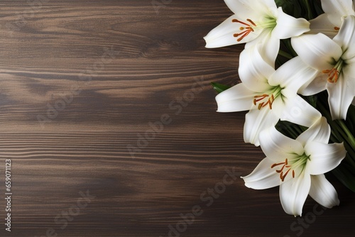 White lily flowers on wooden background. Top view with copy space.Funeral Concept