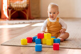 Portrait Of Adorable Infant Baby Playing With Stacking Building Blocks At Home,