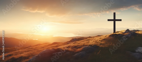 Foto Jesus rising from the dead depicted by cross on a hill at sunrise