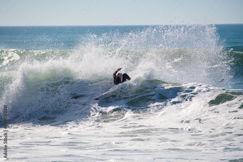 Surfer in a barrel falling under the force of the waves Surfer in a barrel falling under the force of the waves